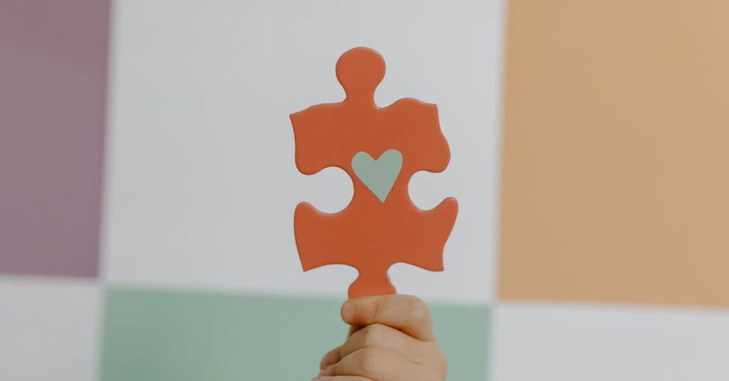 A hand holds a red puzzle piece with a heart, symbolizing connection and awareness.